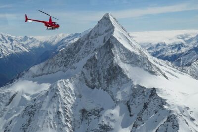 Private Swiss Alps helicopter tour over snow covered mountain peaks and glaciers