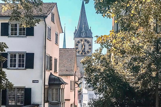 Zurich Highlights In A 2+ Hour Walking Tour Including Panoramic Views - St Peter’s Church and Fraumünster show two sides of the Old Town